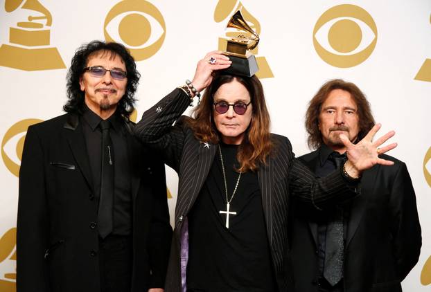 FILE PHOTO: Musicians Tony Iommi, Ozzy Osbourne and Geezer Butler of Black Sabbath pose with their award for Best Metal Performance for "God is Dead?" at the 56th annual Grammy Awards in Los Angeles