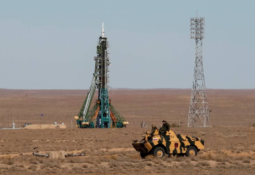 Security personnel drive an armored vehicle past the Soyuz MS-10 spacecraft with the crew of astronaut Nick Hague of the U.S. and cosmonaut Alexey Ovchinin of Russia, shortly before its launch to the International Space Station (ISS) from the launchpad at