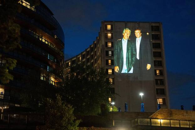 Documents and photos of Jeffrey Epstein and U.S. President Trump projected onto Hilton ahead of WHCA Gala, in Washington, D.C.