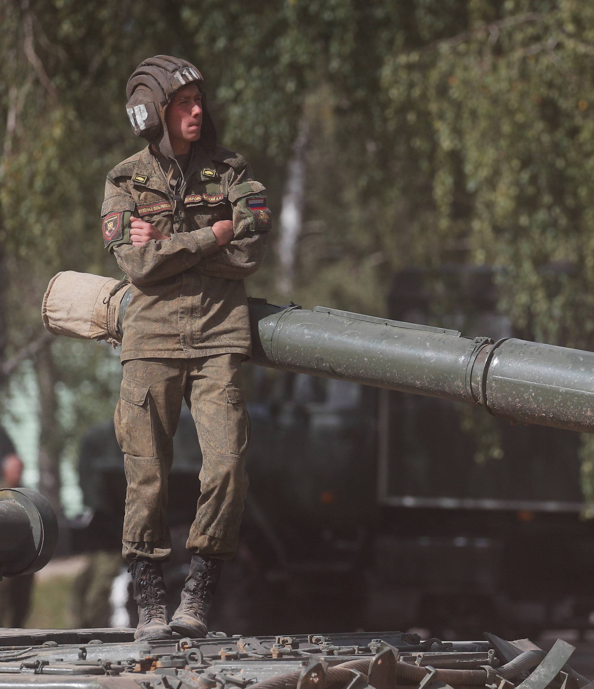 A Russian servicemen stands on an armoured vehicle during the annual international military-technical forum "ARMY" in Alabino