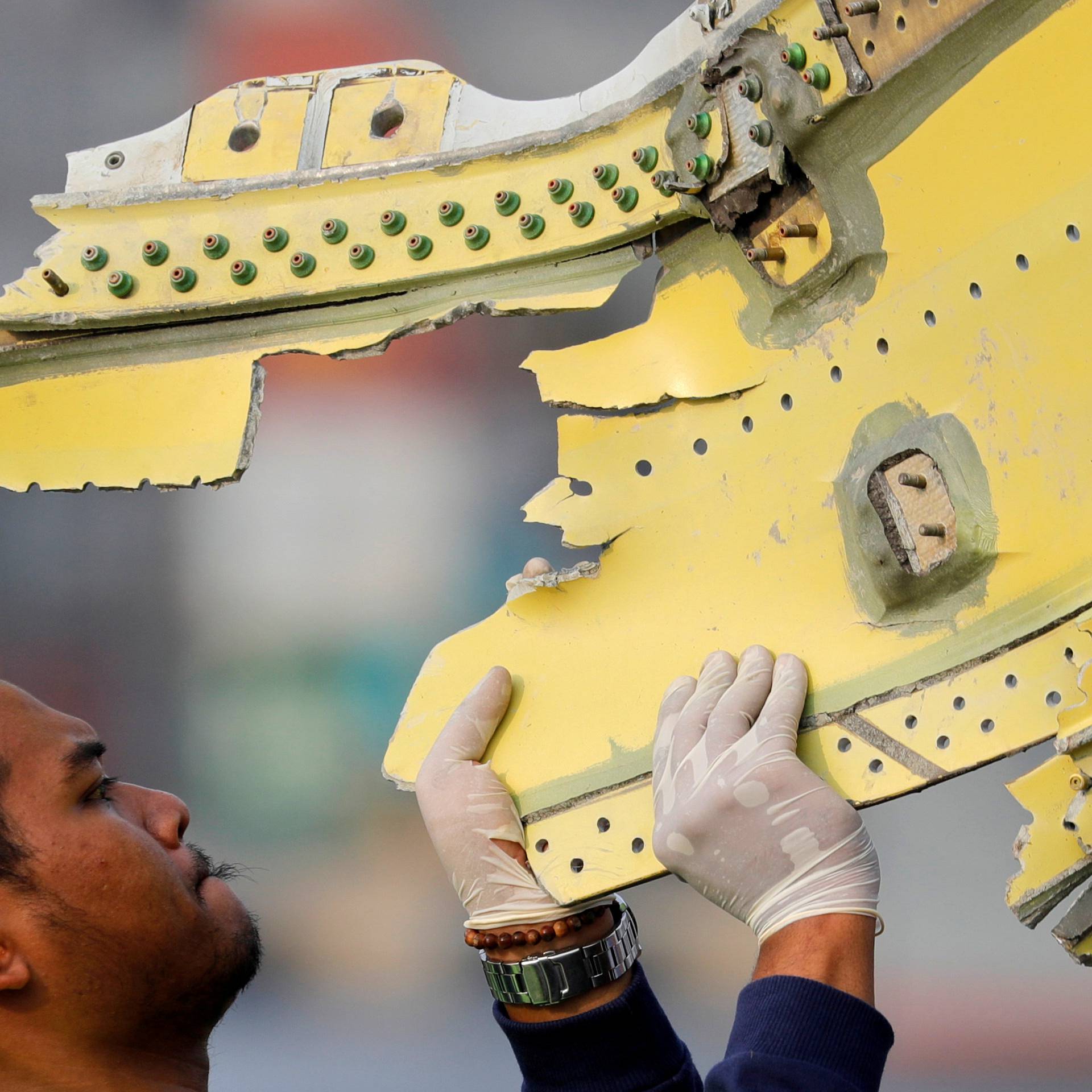 A KNKT official carries debris from the crashed Lion Air flight JT610 at Tanjung Priok port in Jakarta