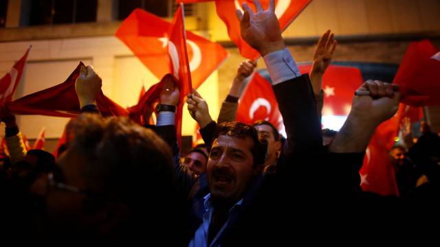 People shout slogans during a protest in front of the Dutch Consulate in Istanbul