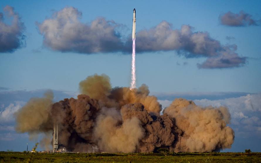 A SpaceX Super Heavy booster carrying the Starship spacecraft lifts off on its 11th test flight