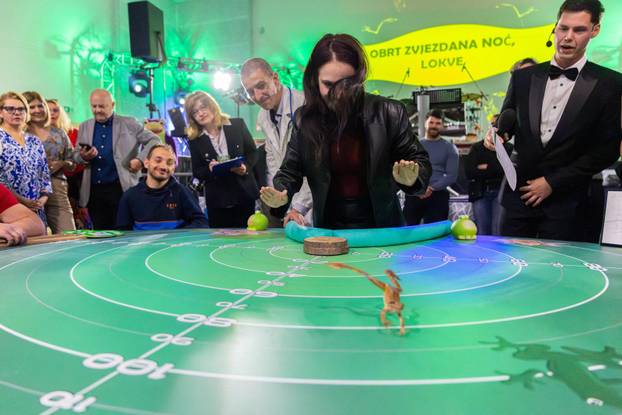 A contestant guides his frog to jump during the 47th Frognight jumping contest in Lokve