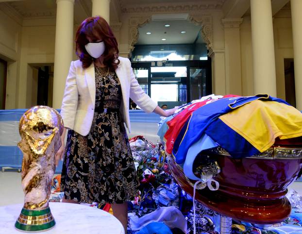 Argentina's Vice President Cristina Fernandez de Kirchner touches the casket of soccer legend Diego Maradona at the presidential palace Casa Rosada, in Buenos Aires