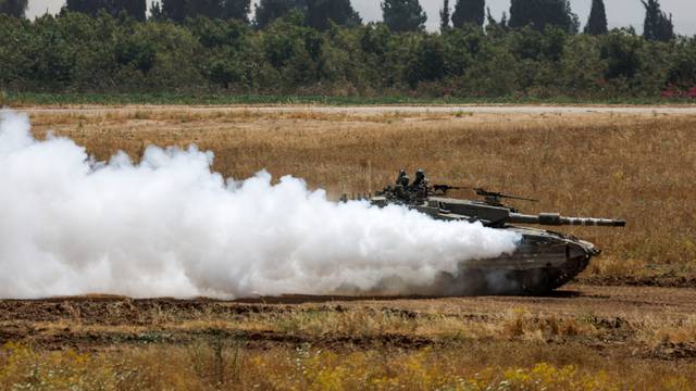 An Israeli tank manoeuvres near the Israel-Gaza border