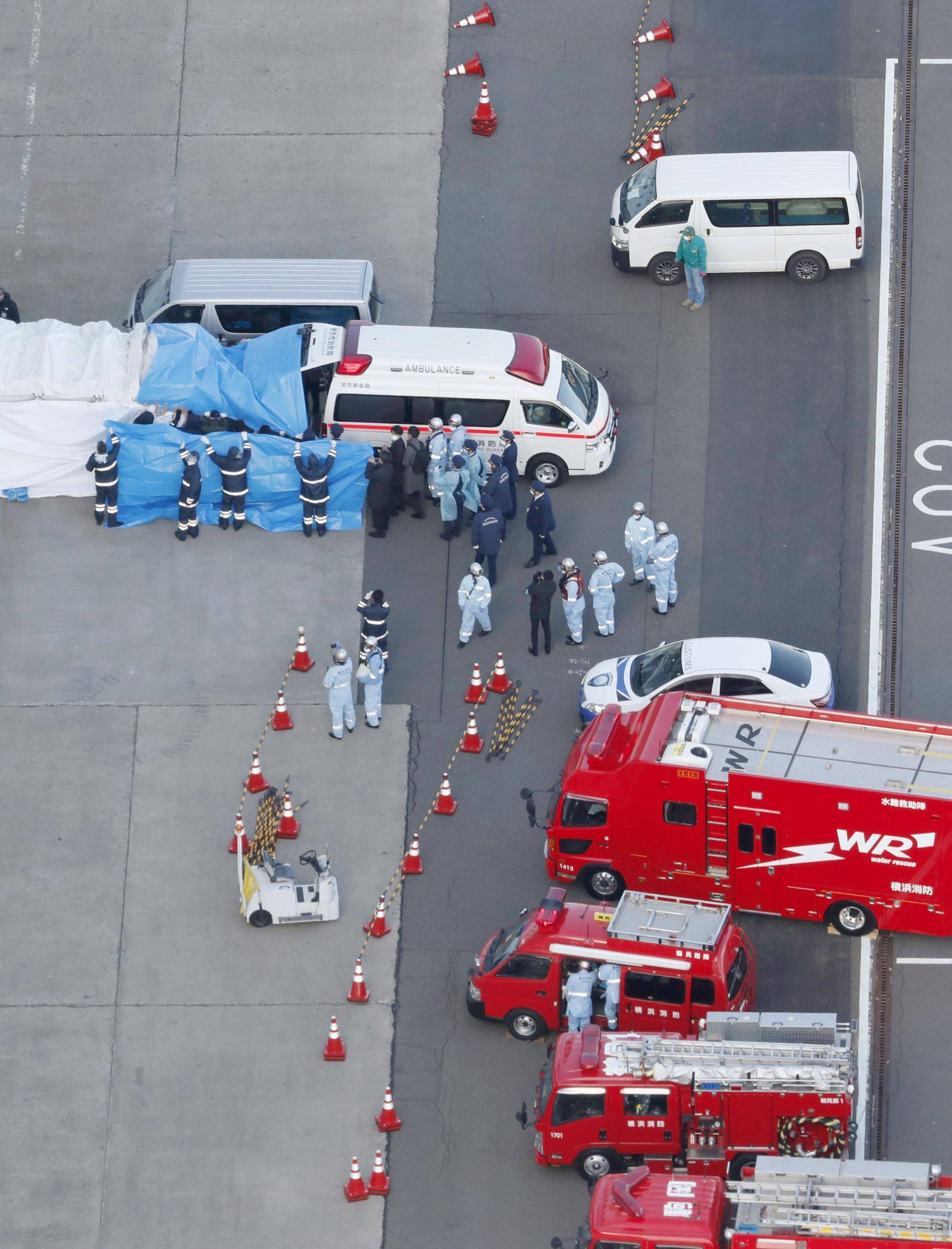 An ambulance, parked near the cruise ship Diamond Princess, which is being used to transfer to hospital people on board who have tested positive for a new coronavirus, is seen at the port of Yokohama