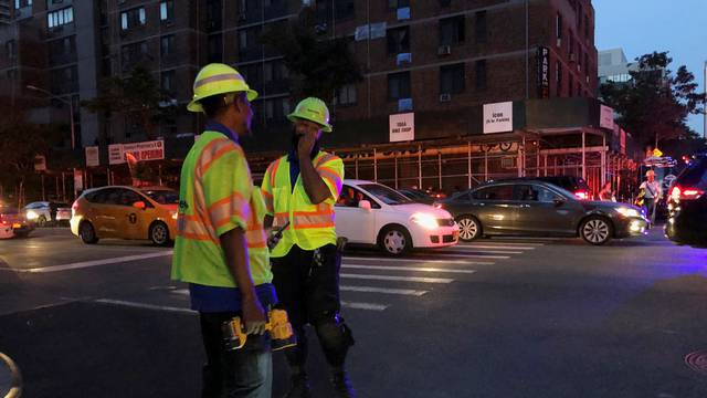 FILE PHOTO: Con Edison workers are seen as blackout affects buildings during widespread power outages in the Manhattan borough of New York