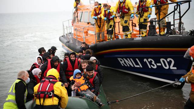 Migrants are brought ashore by a RNLI Lifeboat, after having crossed the channel, in Dungeness