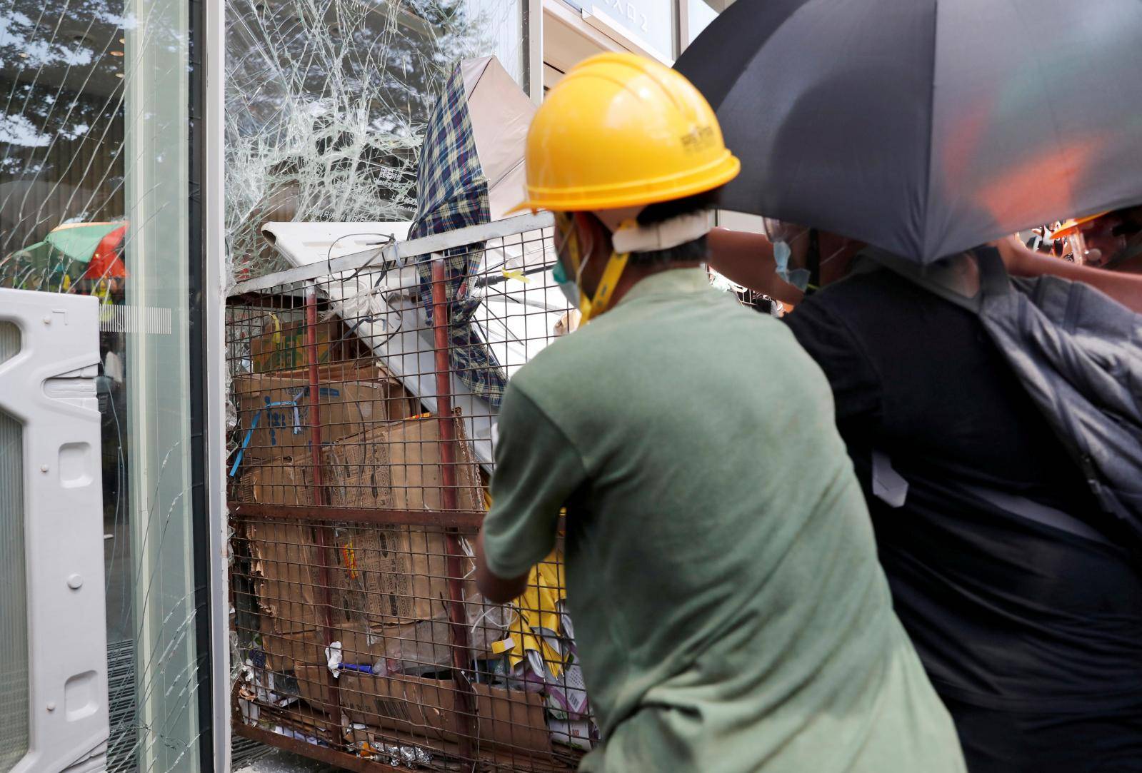 Protesters try to break into the Legislative Council building where riot police are seen, during the anniversary of Hong Kong's handover to China in Hong Kong