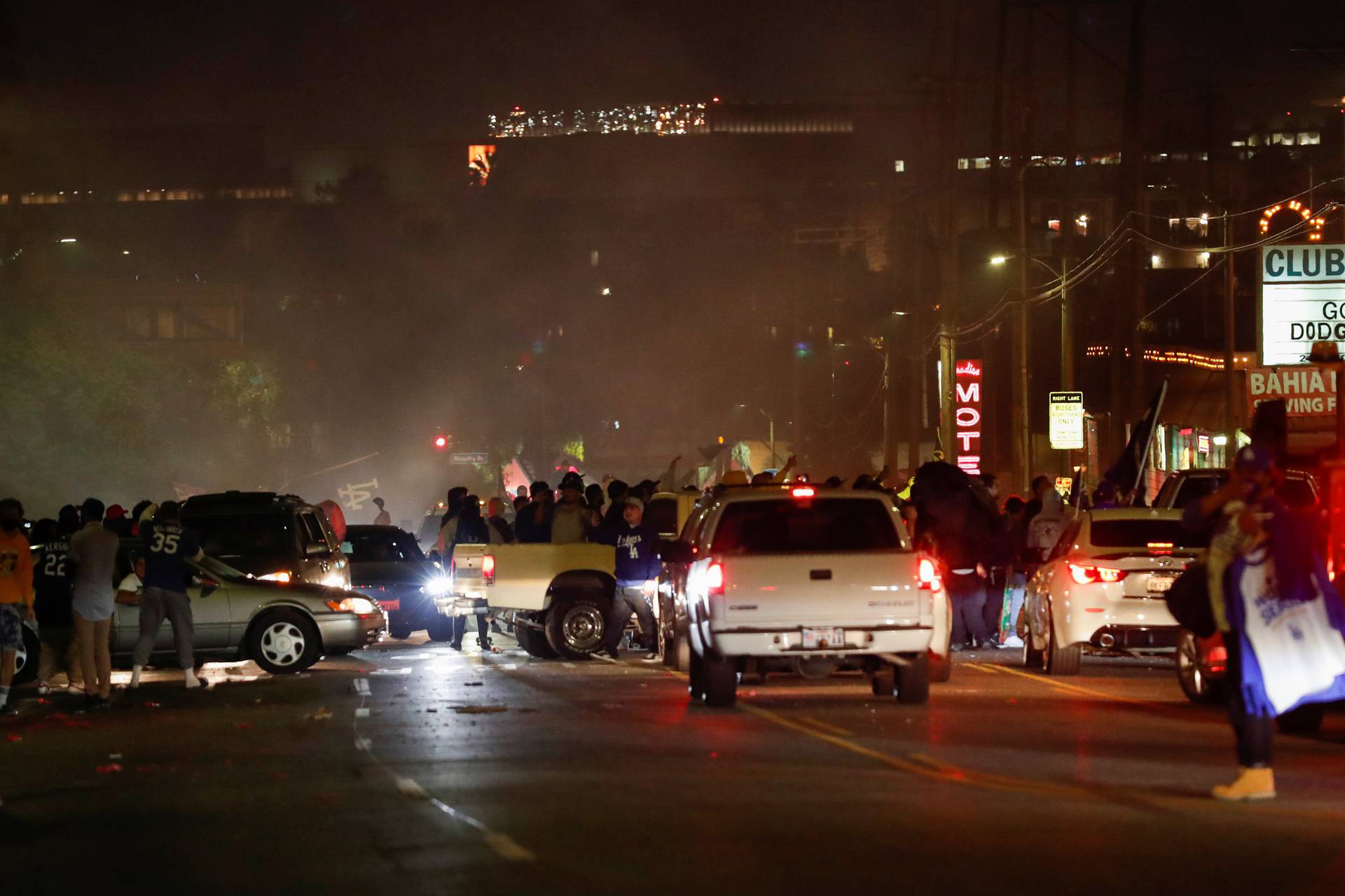 People celebrate Los Angeles Dodgers' victory at the end of game 6 of the 2020 World Series between Los Angeles Dodgers and Tampa Bay Rays, in Los Angeles, California