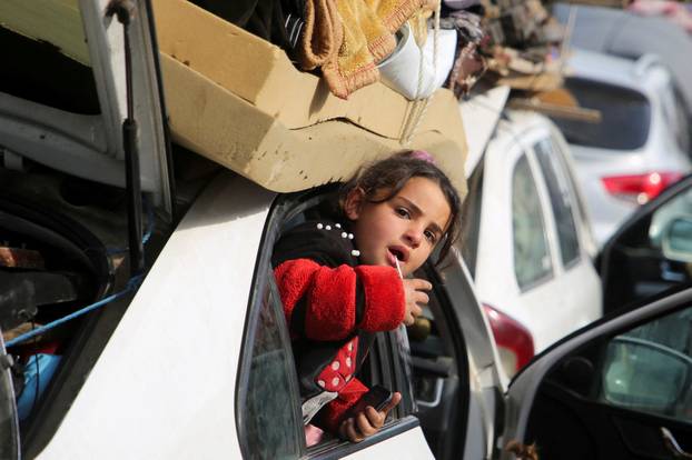Displaced Palestinians wait to be allowed to return to their homes in northern Gaza, in the central Gaza Strip