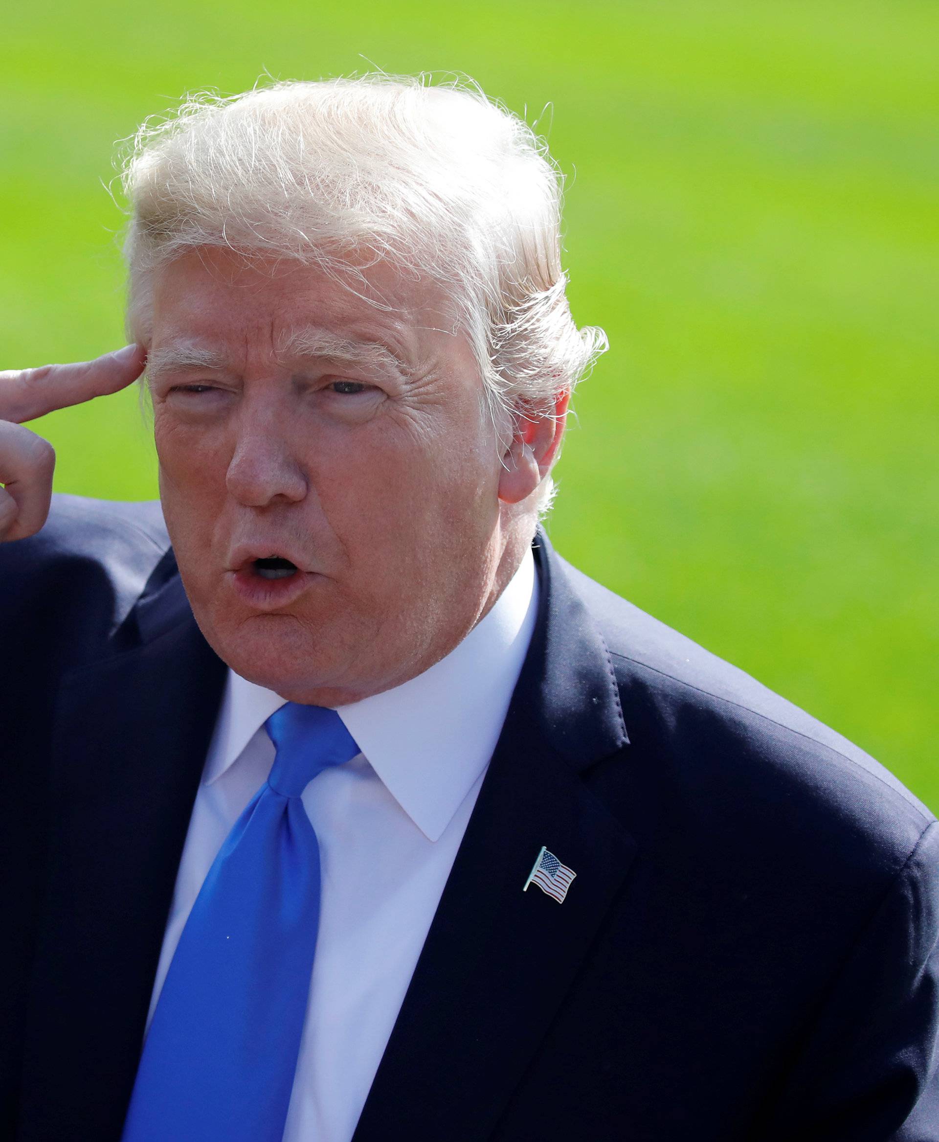 U.S. President Donald Trump talks with reporters as he departs the Oval Office of the White House for Dallas, in Washington D.C.