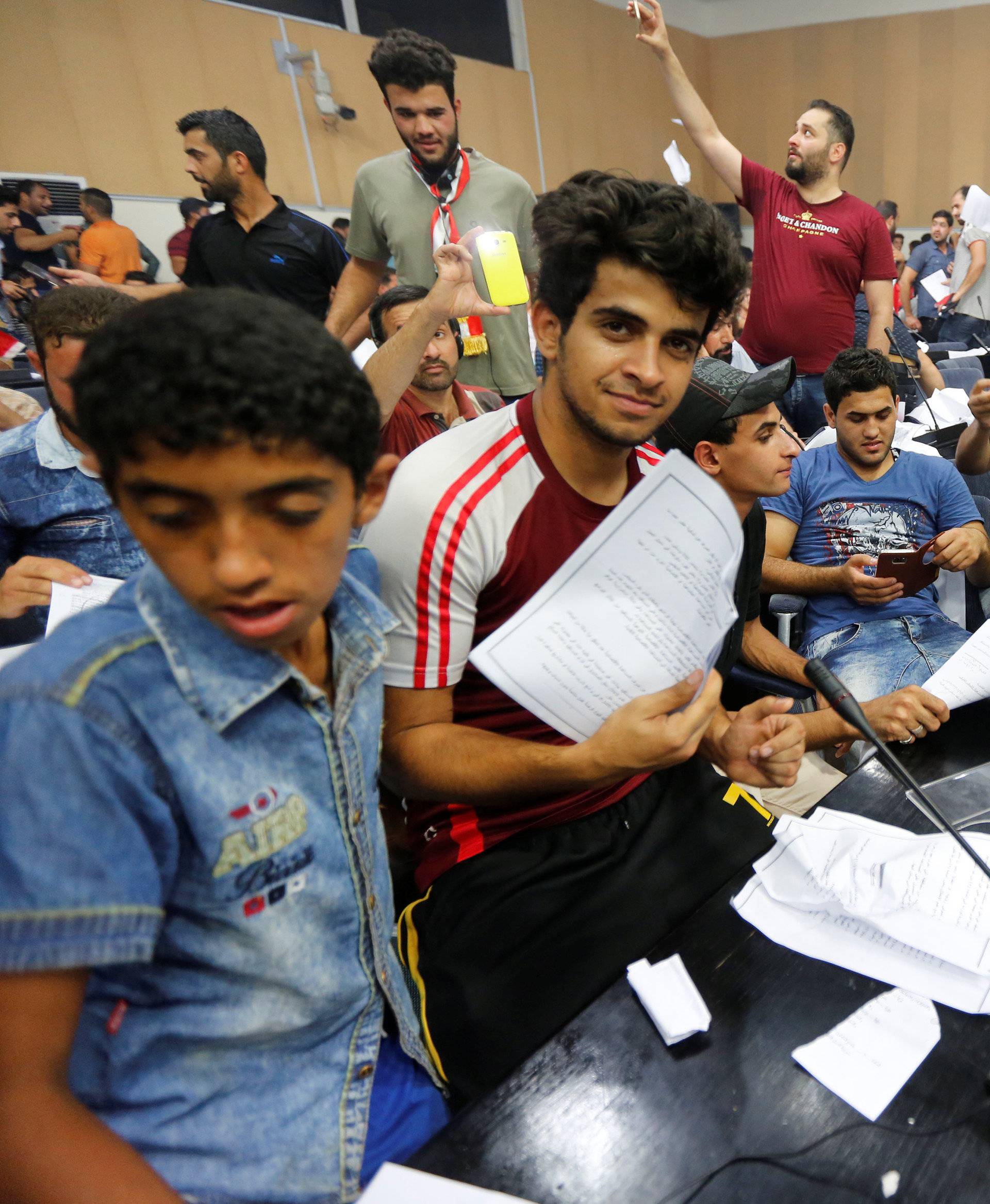 Followers of Iraq's Shi'ite cleric Moqtada al-Sadr are seen in the parliament building as they storm Baghdad's Green Zone after lawmakers failed to convene for a vote on overhauling the government, in Iraq