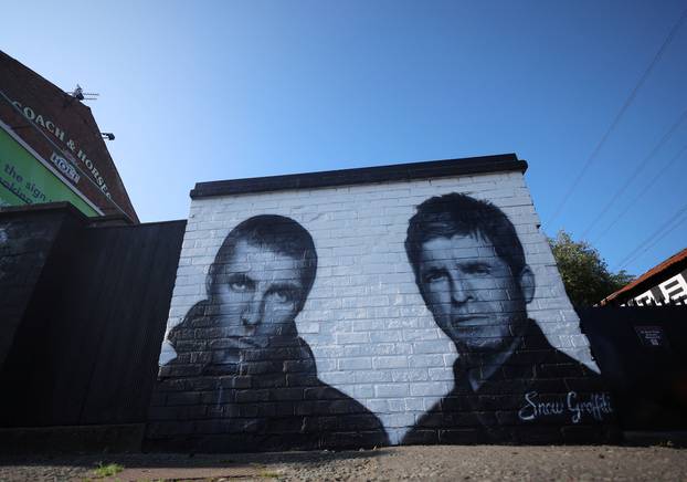 A mural of Oasis band members Liam and Noel Gallagher by artist Snow Graffiti is seen on the wall of the Coach and Horses pub in Whitefield, near Manchester