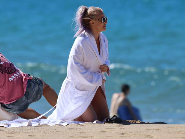 PREMIUM EXCLUSIVE: Britney Spears is seen wearing a pink and black bikini before covering up in a bath robe while on vacation with her boyfriend Sam Asghari