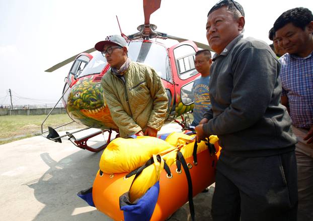 The body of Nepali mountain climber Min Bahadur Sherchan, 85, arrives at a hospital after he died on Saturday, at base camp while on his attempt to become the oldest person to climb Everest