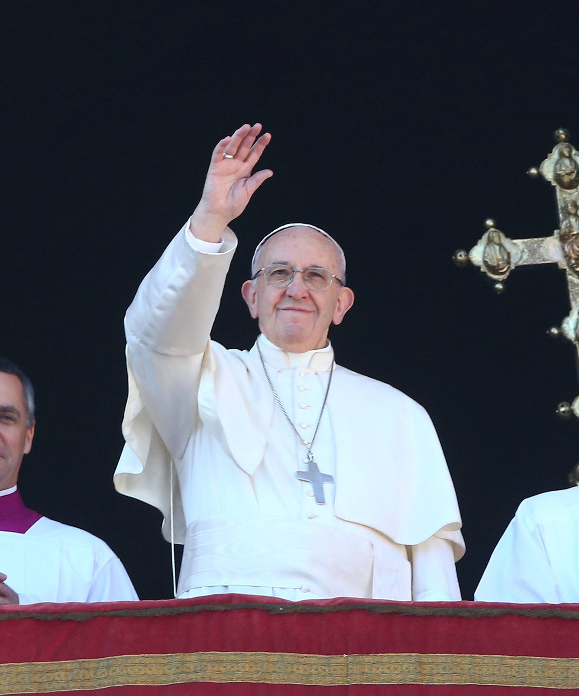 Pope Francis waves as he leads the "Urbi et Orbi" (to the city and the world) message from the balcony overlooking St. Peter's Square at the Vatican