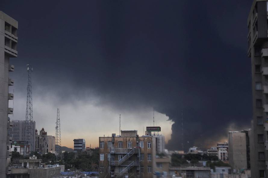 Smoke rises after a reported strike on fuel tanks at an oil refinery, amid the U.S.-Israeli conflict with Iran, in Tehran