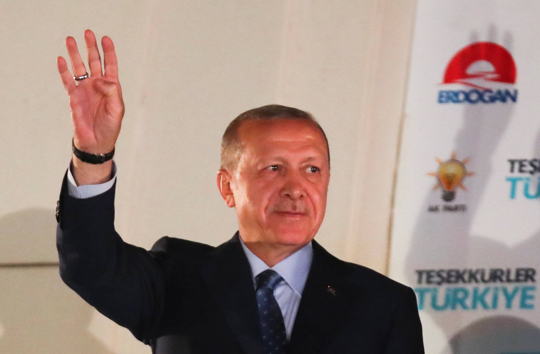 Turkish President Tayyip Erdogan greets his supporters at the AKP headquarters in Ankara