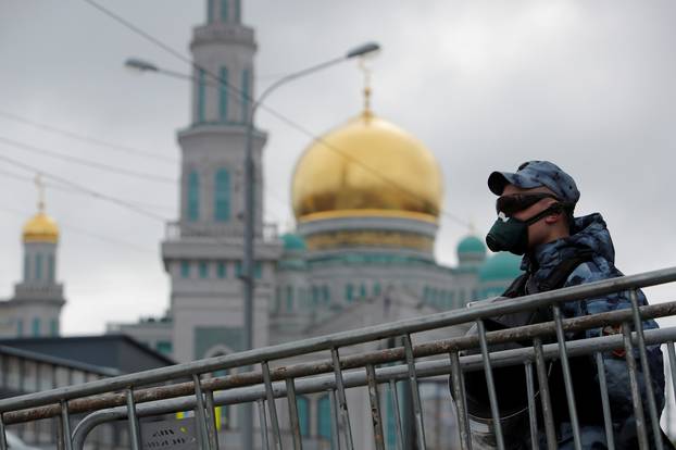 FILE PHOTO: A law enforcement officer stands guard outside the closed Moscow Cathedral Mosque
