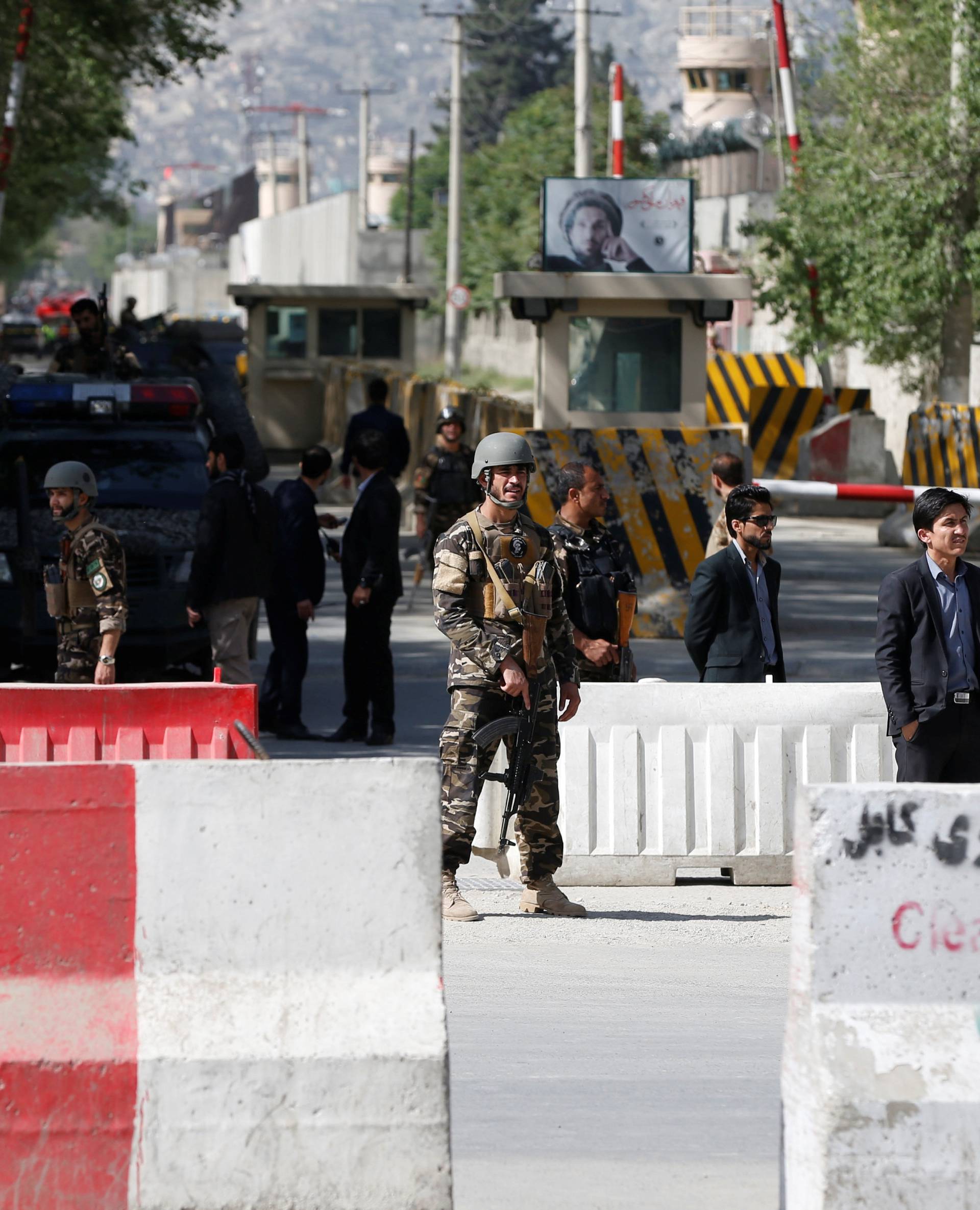 Afghan security forces stand guard near the site of a blast in Kabul, Afghanistan