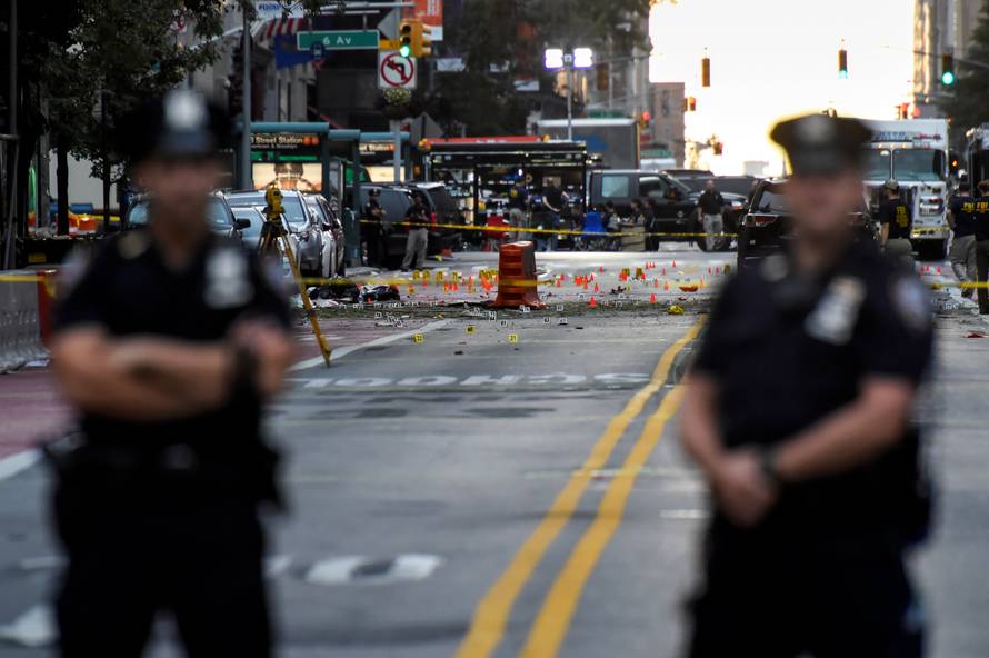 NYPD officers stand near the site of an explosion in New York