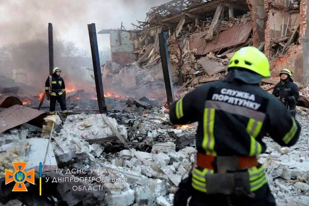 Rescuer works among remains of buildings damaged by airstrike in Dnipro