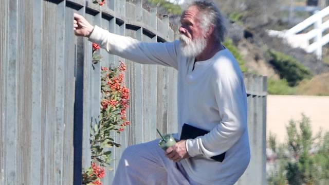 *EXCLUSIVE* Nick Nolte climbs a fence in his PJ's in Malibu