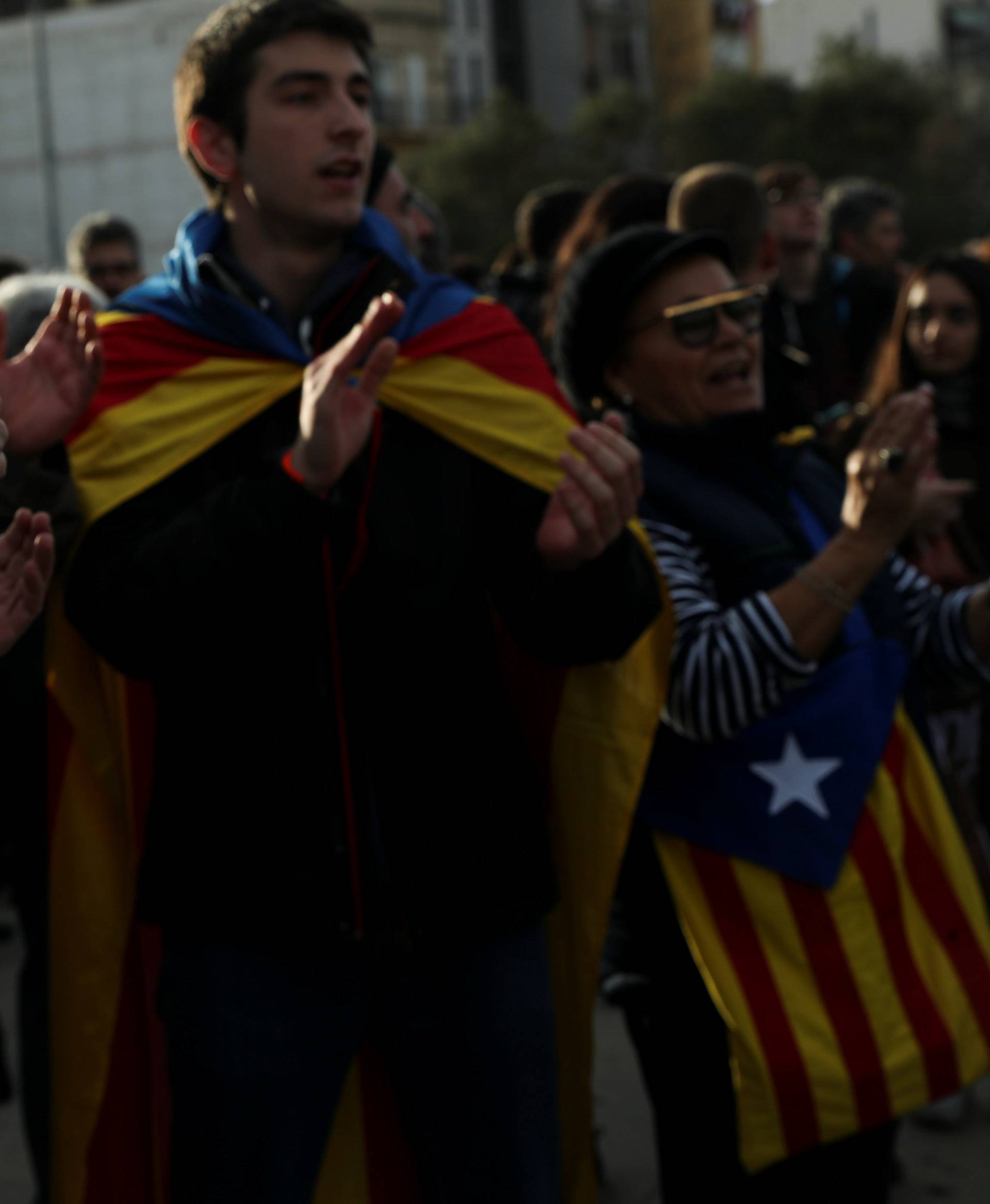 People carry a banner with the sketches of jailed leaders of Catalan pro-independence movements ANC and Omnium Cutural, Sanchez and Cuixart, during a protest against the imprisonment of Catalan separatist leaders outside Sants t