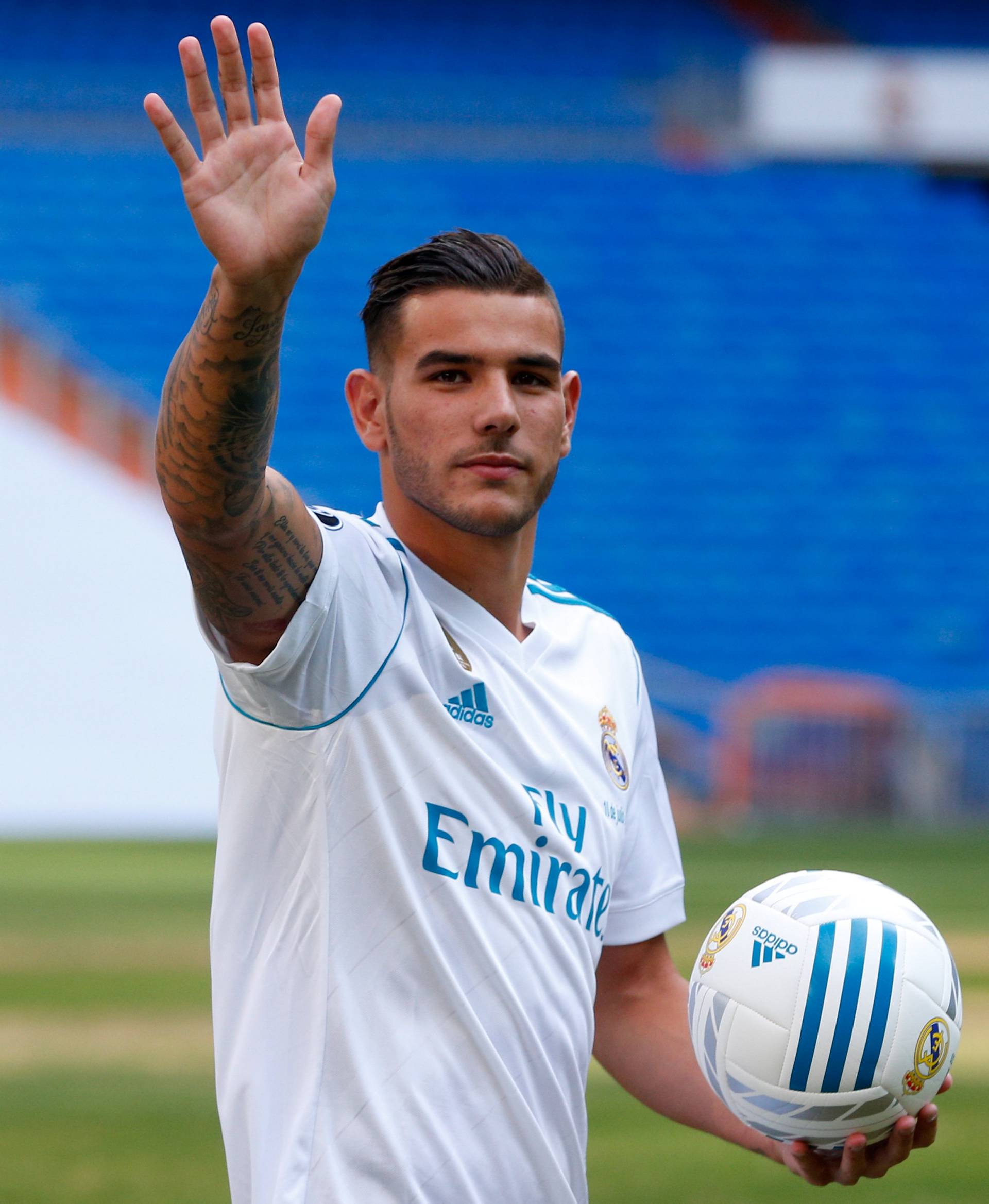 Real Madrid's new player Theo Hernandez waves during his presentation at the Santiago Bernabeu Stadium in Madrid