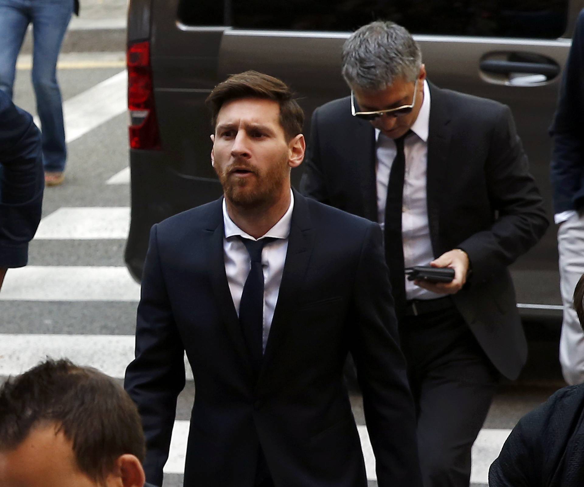 Barcelona's Argentine soccer player Lionel Messi arrives to court with his father Jorge Horacio Messi to stand trial for tax fraud in Barcelona