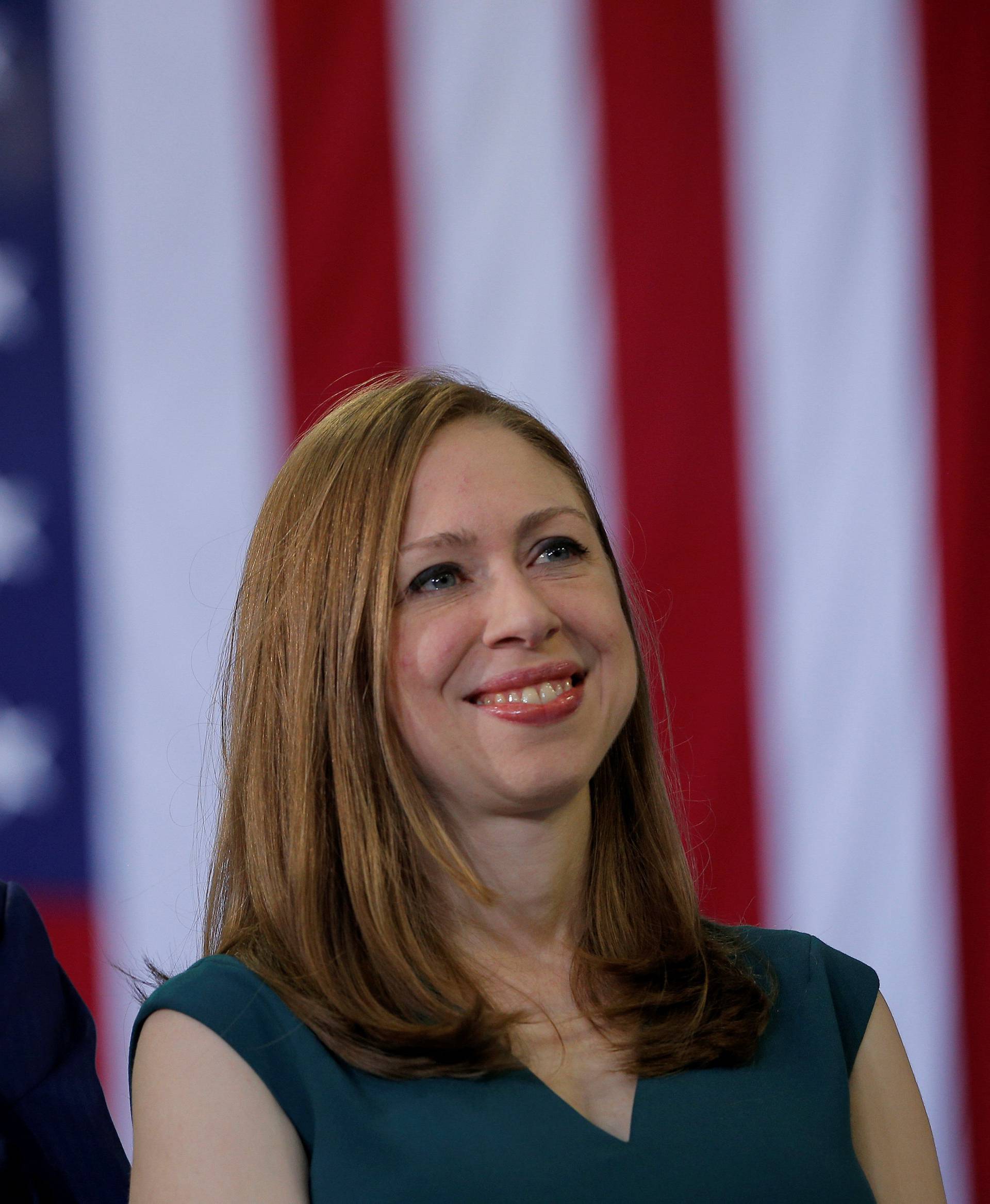 Former U.S. President Bill Clinton and Chelsea Clinton listen as U.S. Democratic presidential nominee Hillary Clinton speaks at a campaign rally in Raleigh