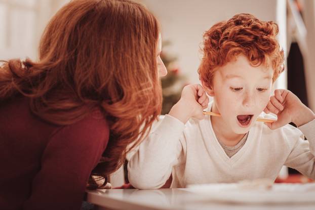 Close up of surprised child holding a pencil