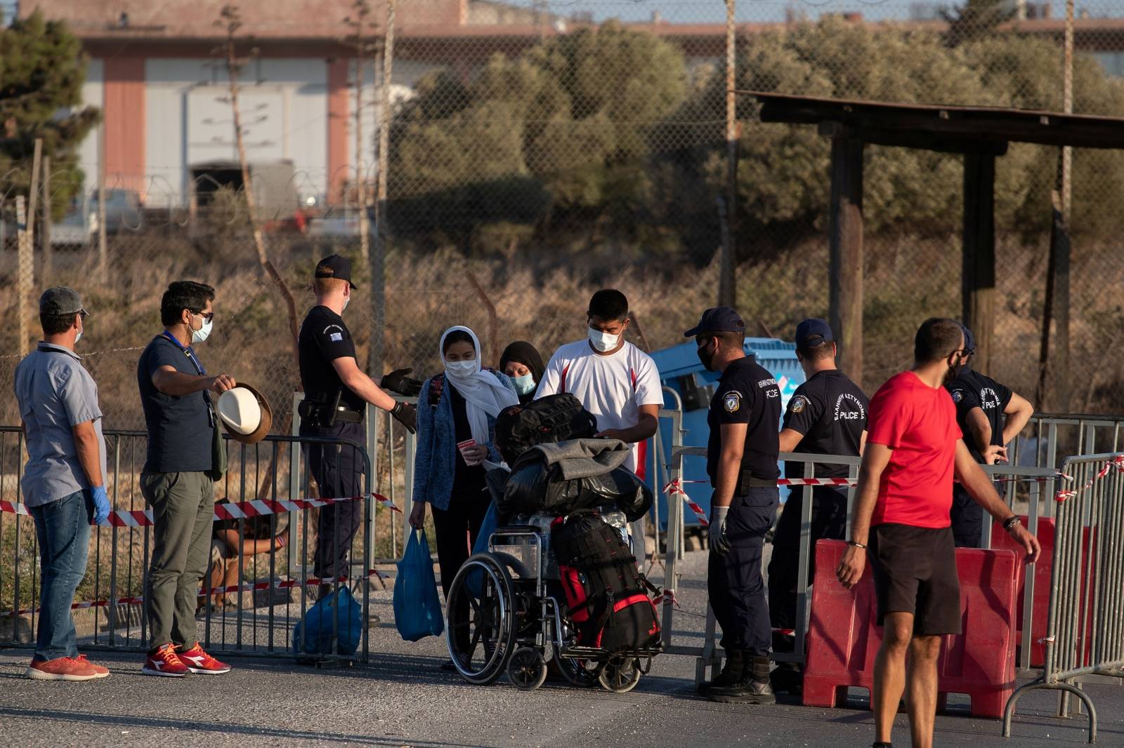 A family from the destroyed Moria camp for refugees and migrants arrives at a new temporary camp, on the island of Lesbos