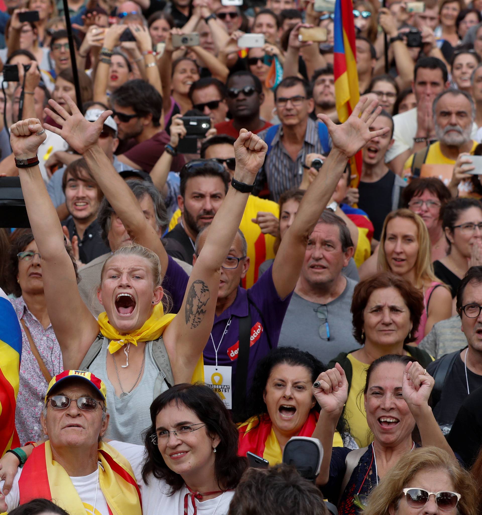 People celebrate after the Catalan regional parliament passes the vote of the independence from Spain in Barcelona