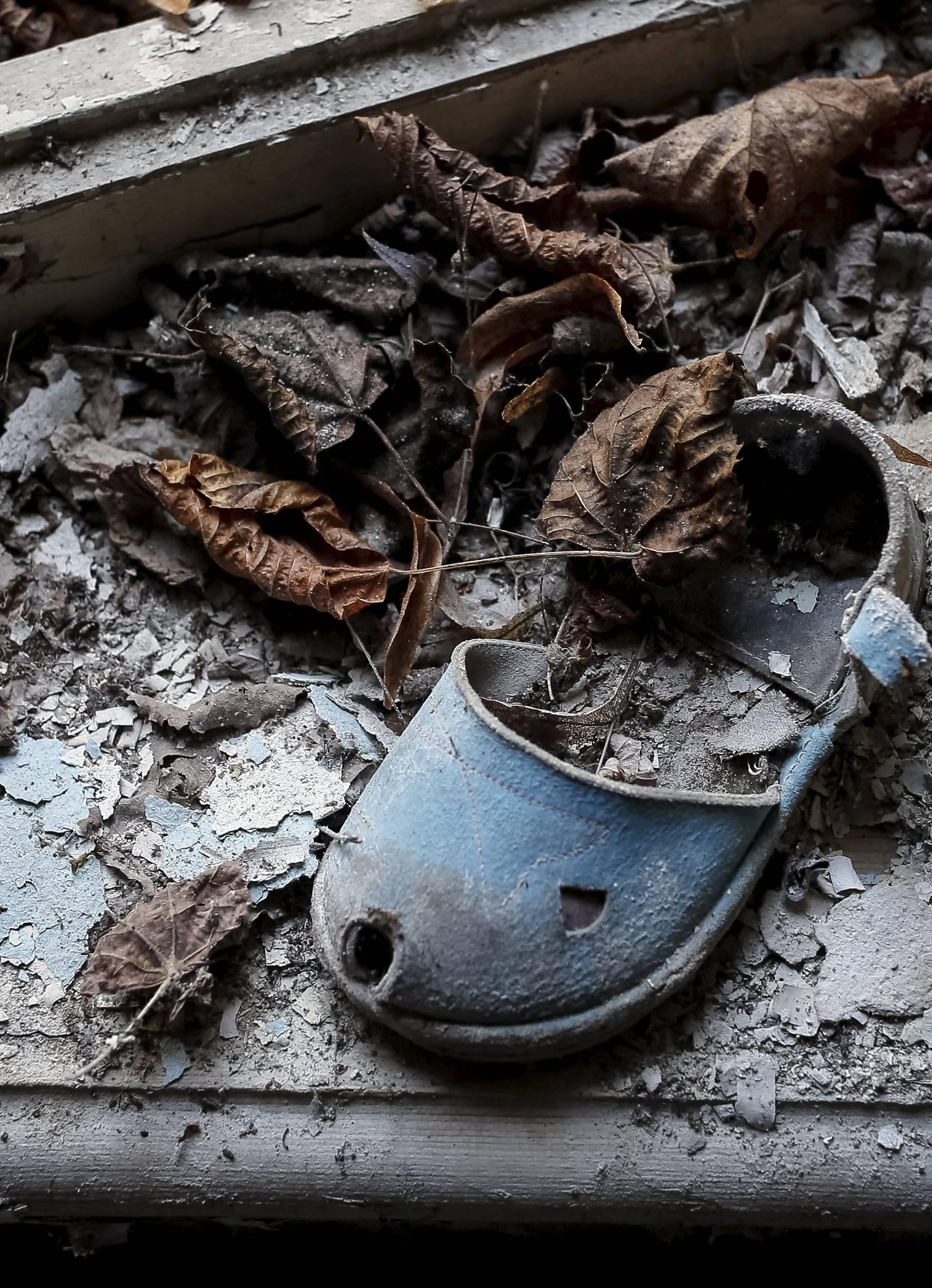 A shoe for children is left in a kindergarten in the abandoned city of Pripyat near the Chernobyl nuclear power plant
