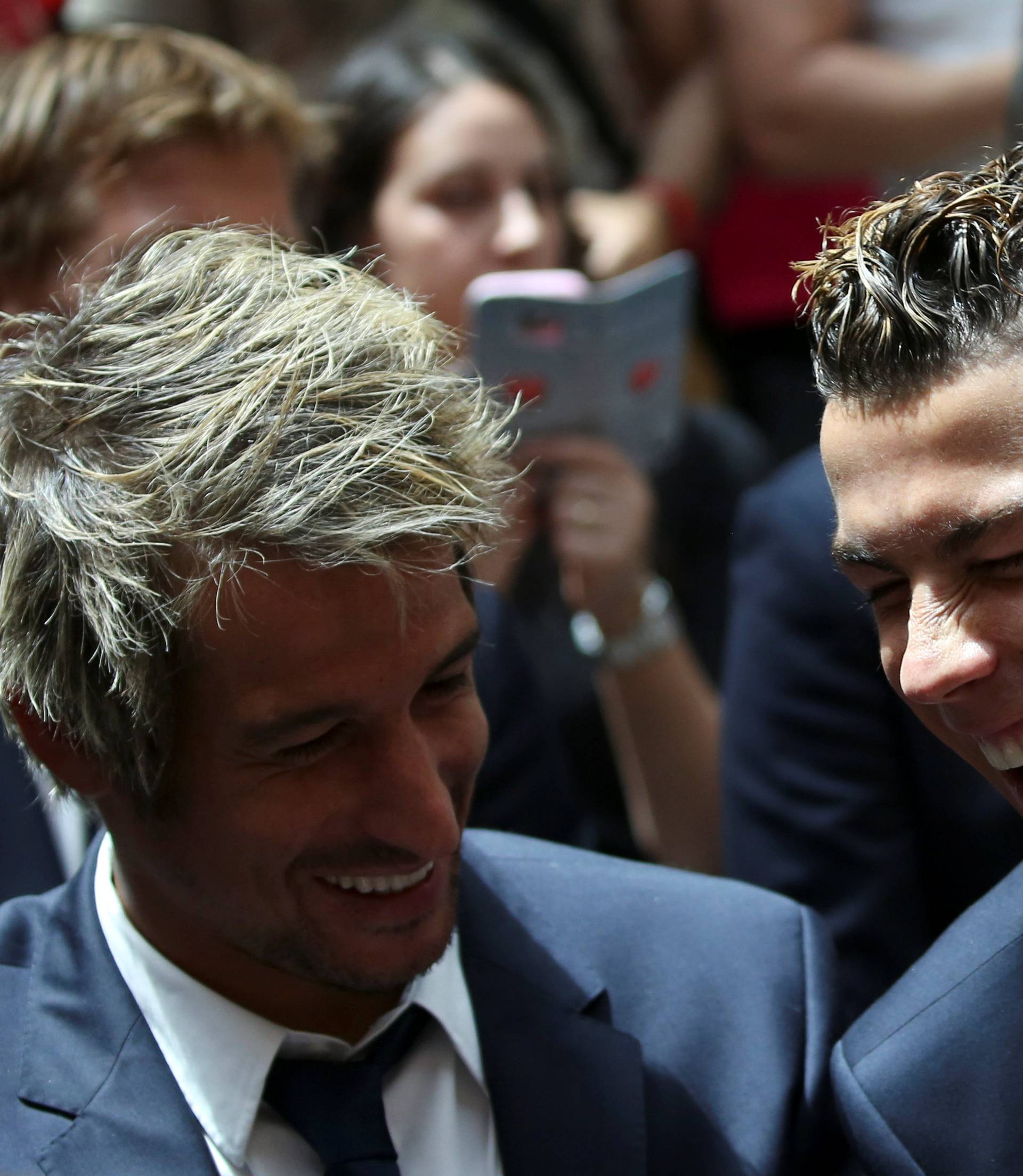 Real Madrid's Cristiano Ronaldo and teammate Coentrao attend a ceremony after winning La Liga title at the headquarters of Madrid's regional government in Madrid