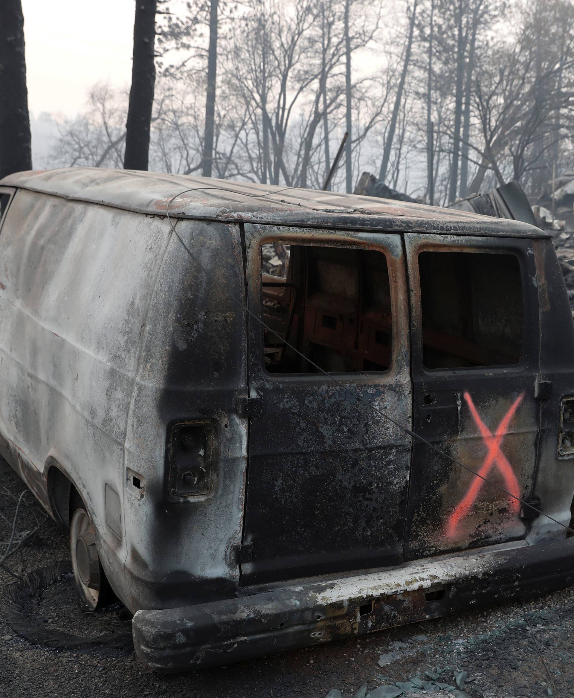 A van marked by search crews is seen in the aftermath of the Camp Fire in Paradise