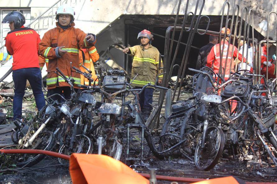 Firefighters are seen at thesite of a blast at the Pentecost Church Central Surabaya (GPPS), in Surabaya, East Java