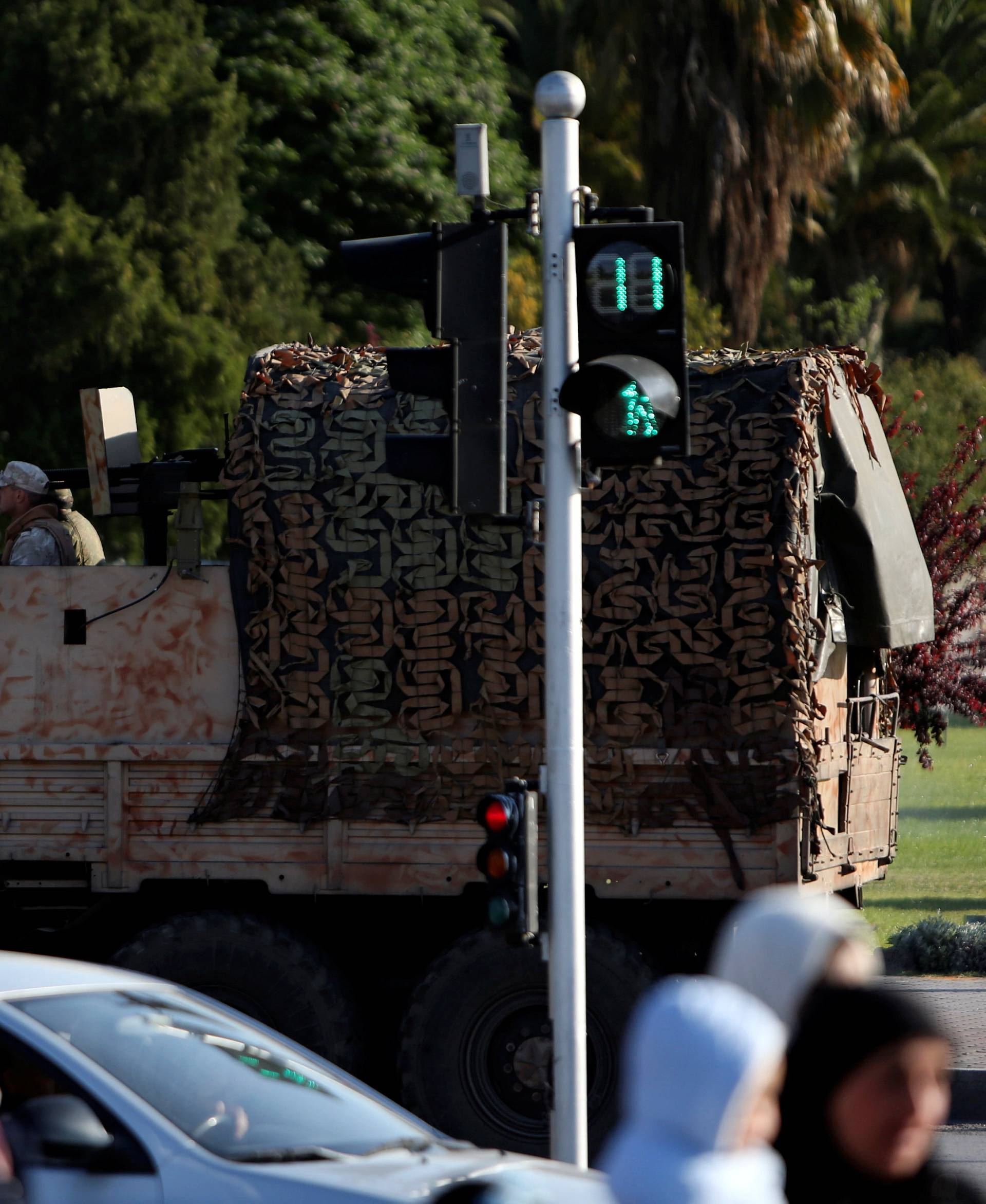 A Russian soldier is seen on a military vehicle along a street in Damascus