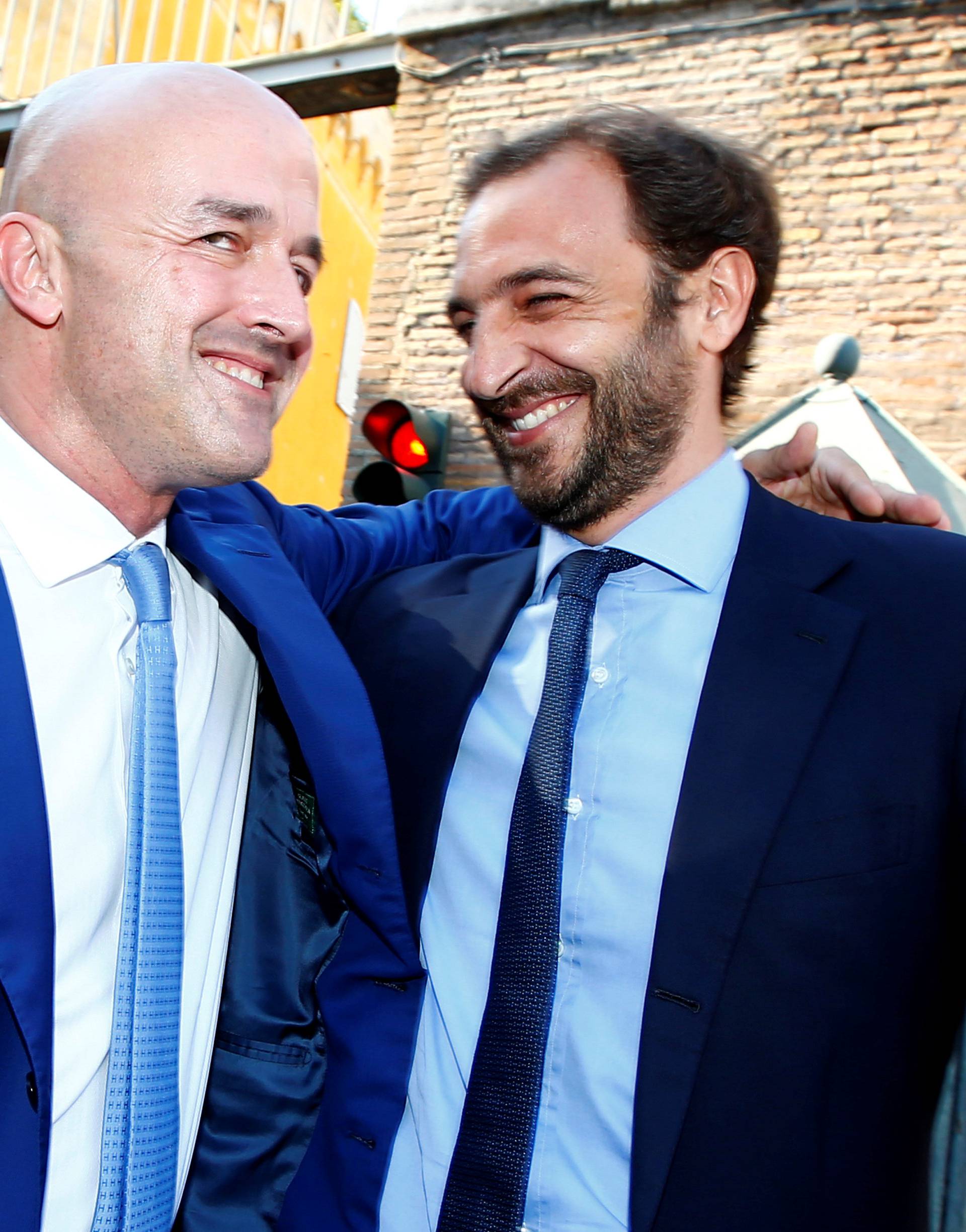 Journalists Fittipaldi and Nuzzi smile as they leave the Vatican at the end of their trial