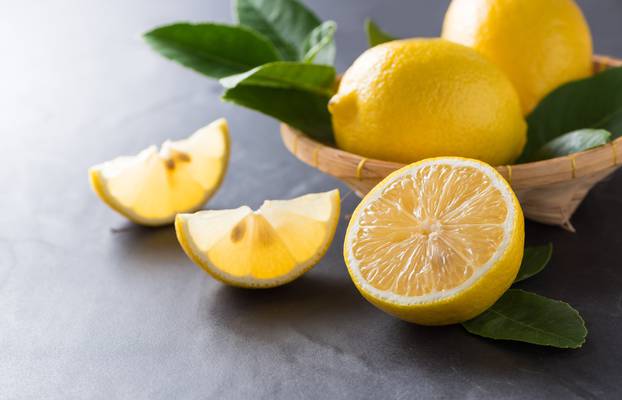 fresh sliced lemon on dark marble stone 