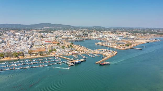 Aerial view of Portuguese fishing tourist town of Olhao with a view the Ria Formosa Marine Park. Sea port for yachts moored at the berths