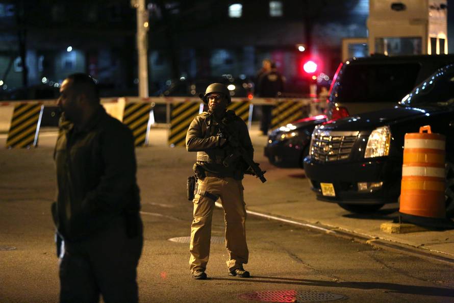 United States Marshals Service officers assist a motorcade believed to be transporting Joaquin "El Chapo" Guzman at the Manhattan Detention Complex in the Manhattan borough of New York City, New York, U.S.