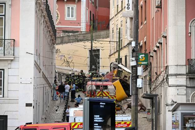 First responders work at the site of a funicular accident in Lisbon