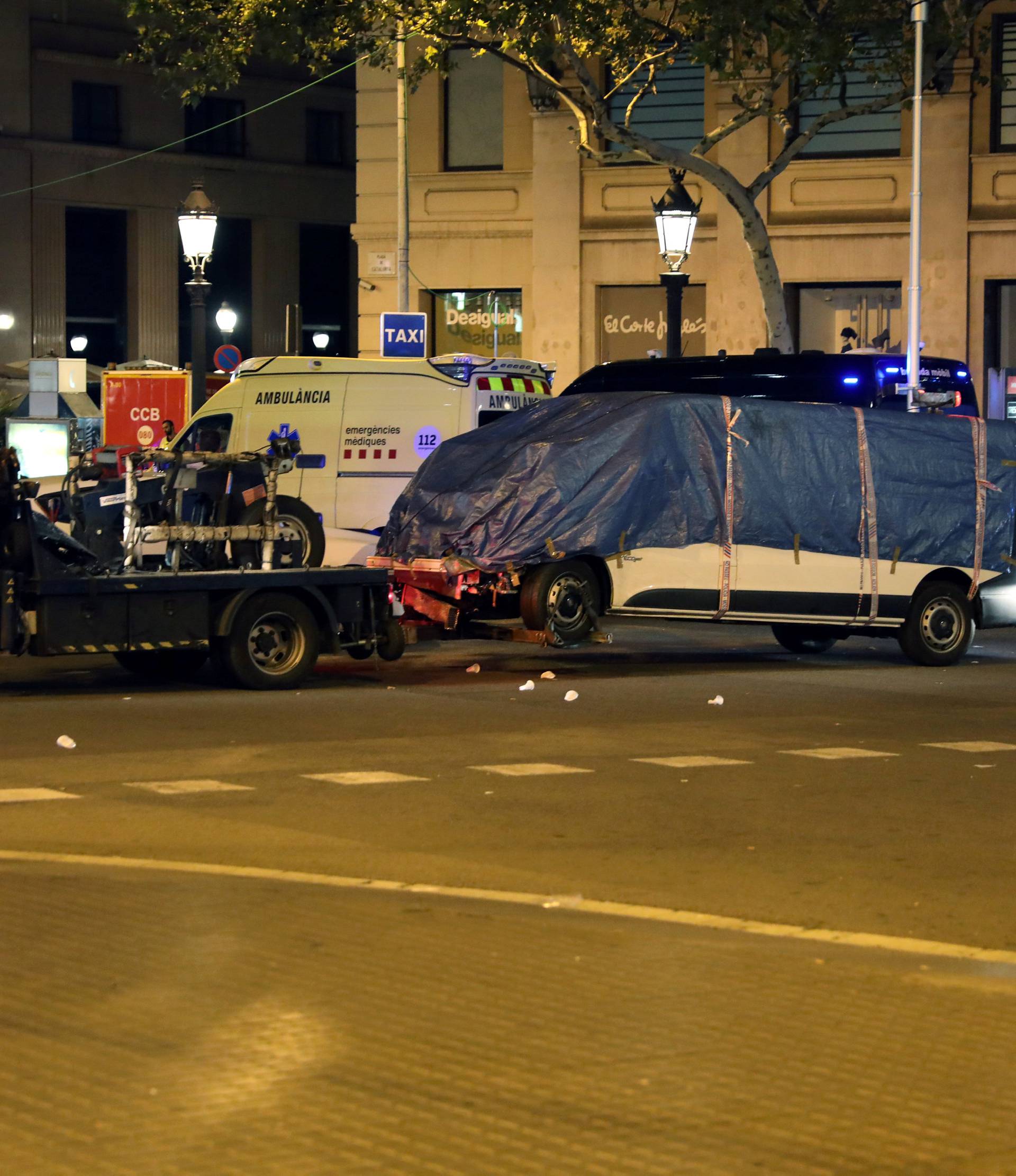 The suspected van is towed away from the area where it crashed into pedestrians at Las Ramblas in Barcelona