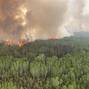 Smoke rises from the Paskwa Wildfire (HLW030) as it burns near the Wood Buffalo National Park boundary