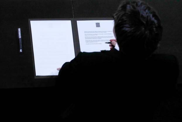 Catalan President Carles Puigdemont signs a declaration of independence Catalan regional parliament in Barcelona