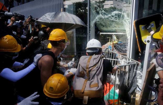 Protesters try to break into the Legislative Council building during the anniversary of Hong Kong